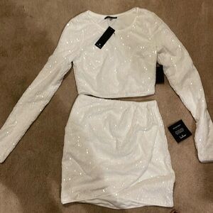 Lulu’s white sequined crop top and scalloped mini skirt